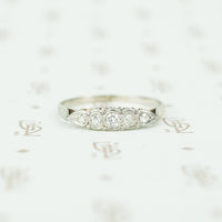 Platinum and white gold diamond band with a paisley like design