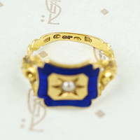 close up of hallmark details on 18k gold enameled panel ring