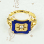 close up of hallmark details on 18k gold enameled panel ring