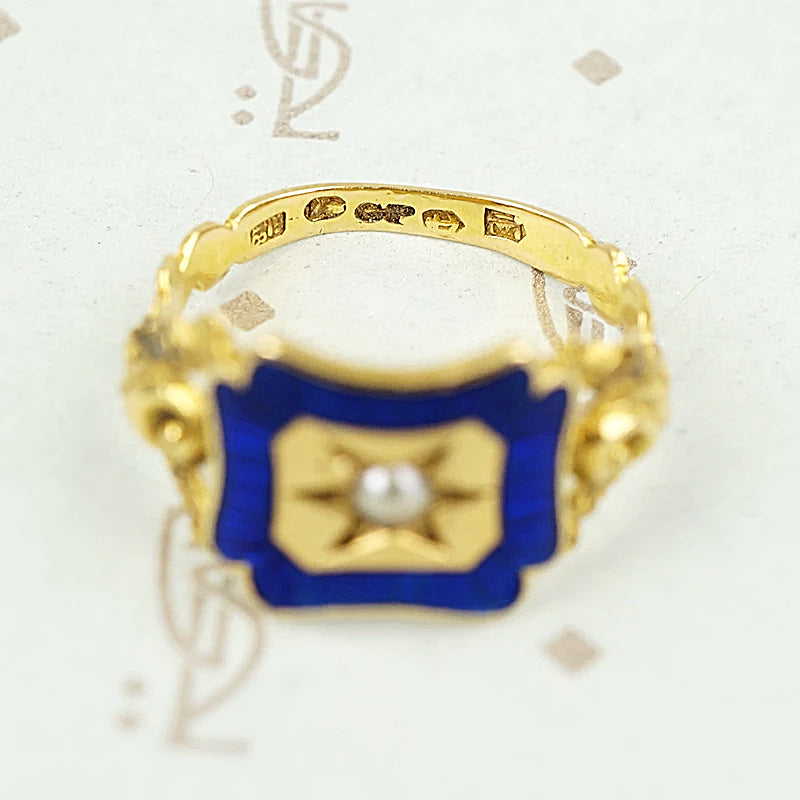 close up of hallmark details on 18k gold enameled panel ring
