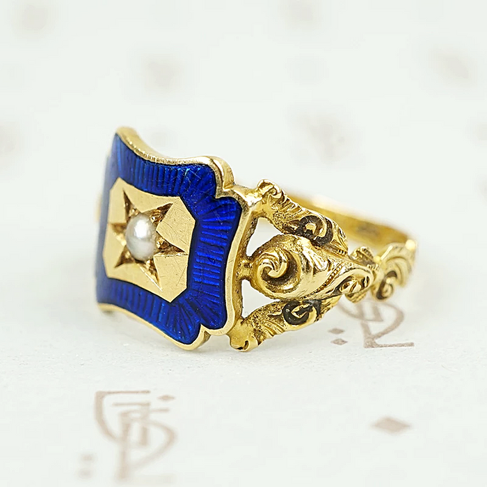 shoulder view of early gold ring featuring roses