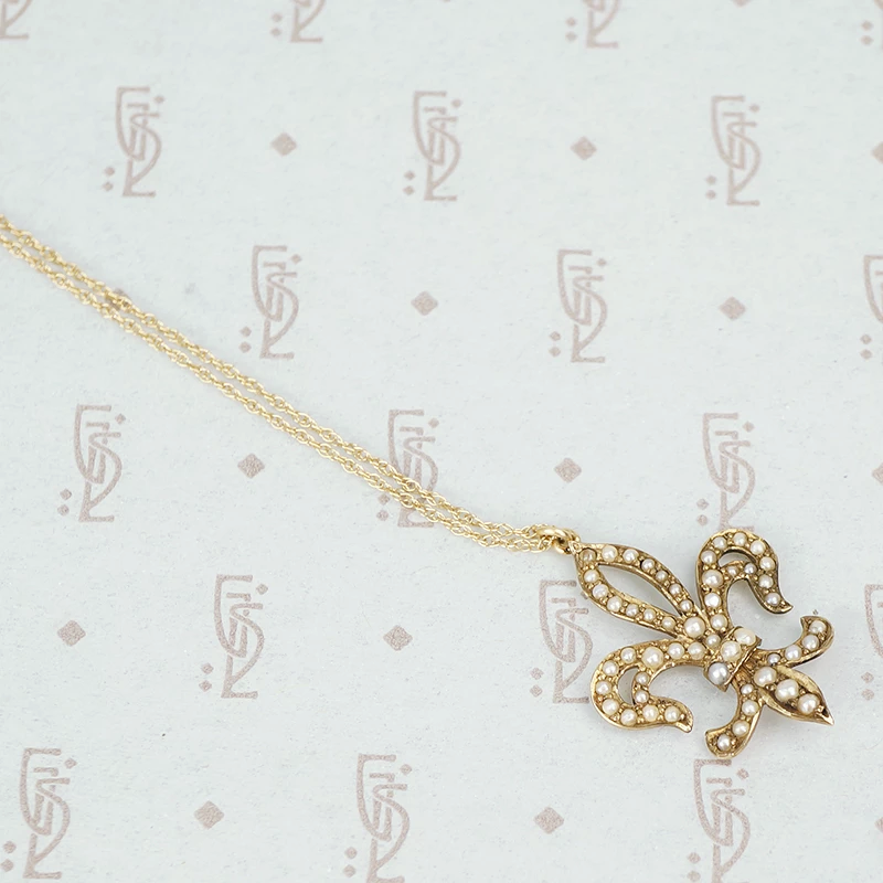 gold fleur de lis pendant set with pearls