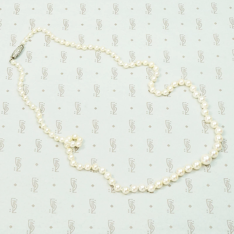20" long graduated pearls with a Platinum and old mine cut diamond clasp