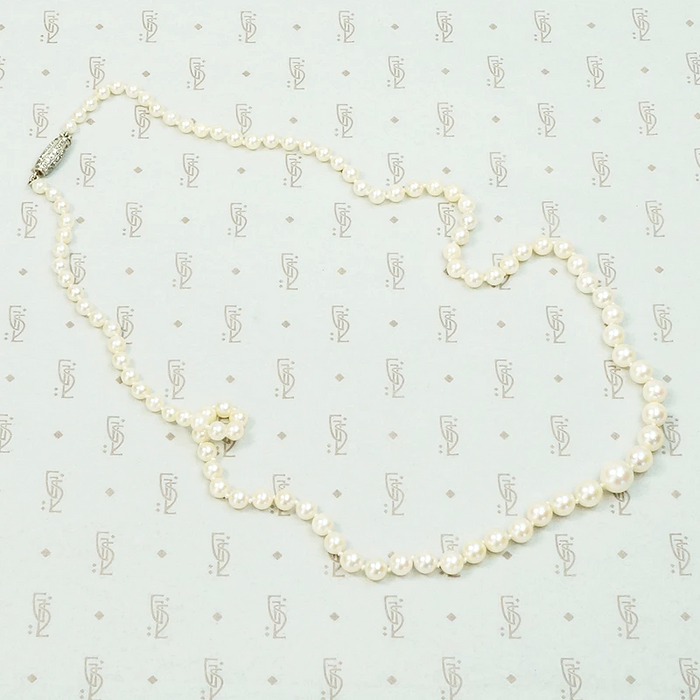 20" long graduated pearls with a Platinum and old mine cut diamond clasp