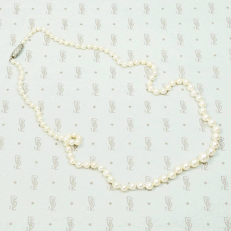 20" long graduated pearls with a Platinum and old mine cut diamond clasp