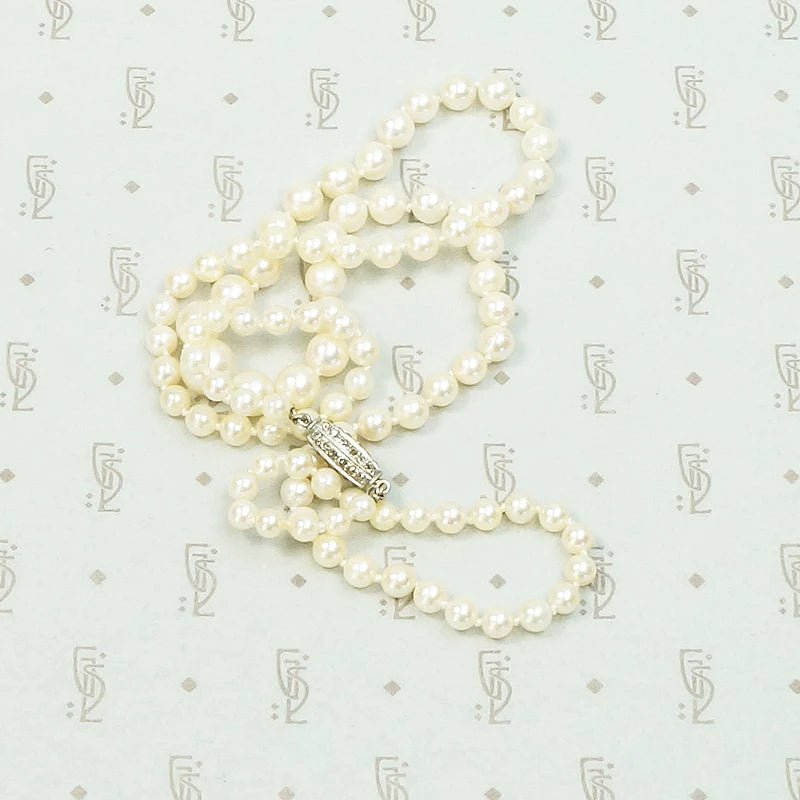 20" long graduated pearls with a Platinum and old mine cut diamond clasp