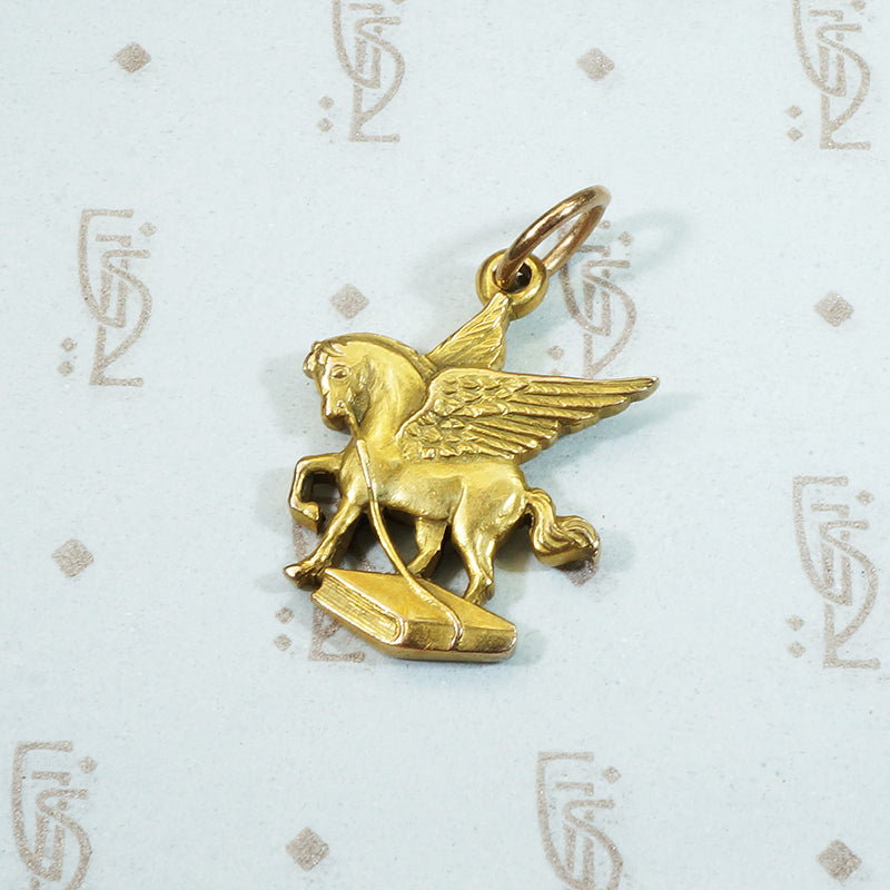 14k yellow gold pegasus carrying a book