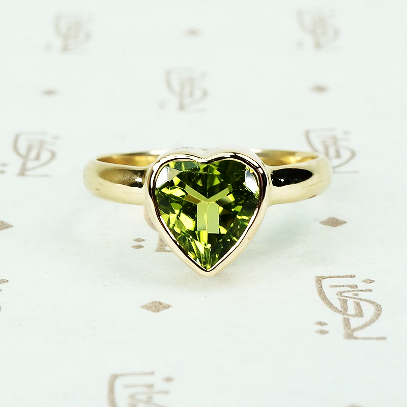 green peridot heart ring in recycled 14k yellow gold