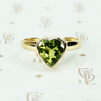 green peridot heart ring in recycled 14k yellow gold