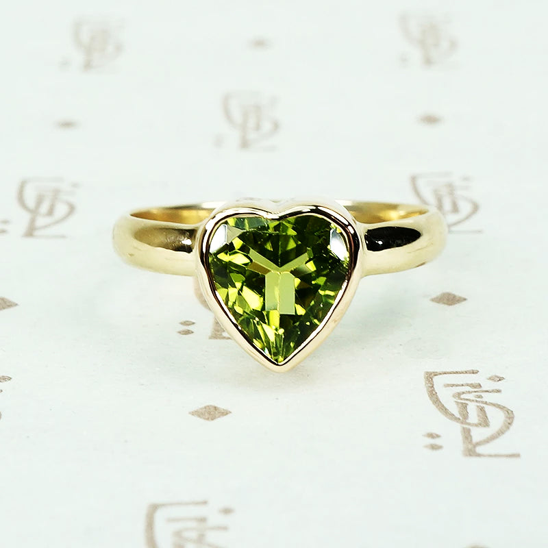 green peridot heart ring in recycled 14k yellow gold