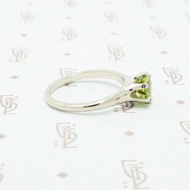 1 carat green peridot solitaire in recycled white gold