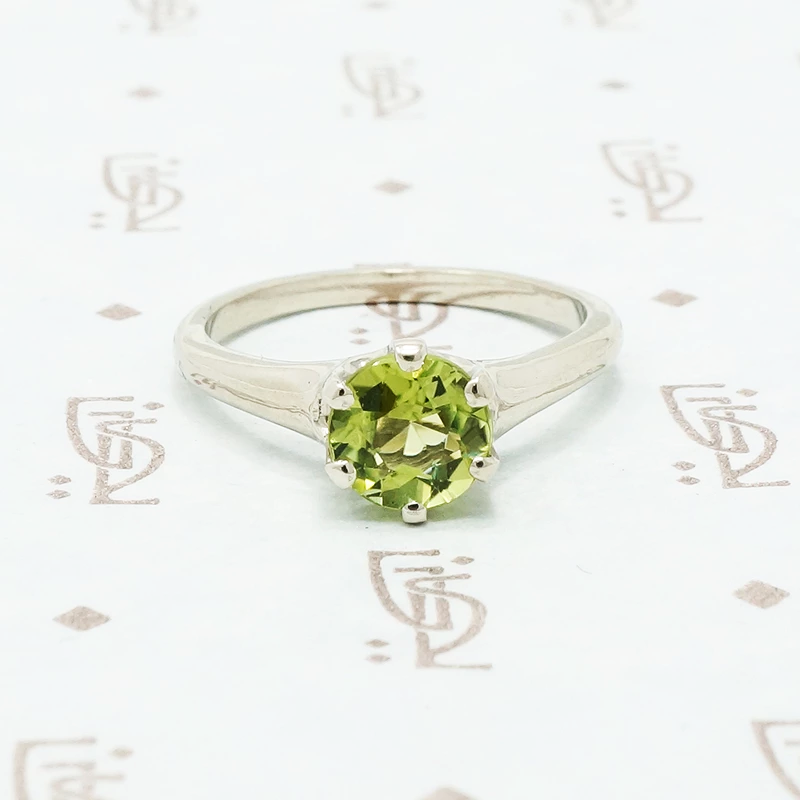 1 carat green peridot solitaire in recycled white gold