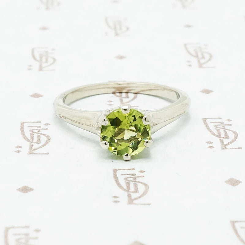 1 carat green peridot solitaire in recycled white gold