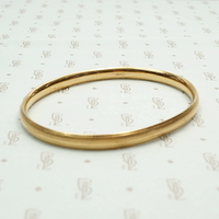Engraved Gold Vintage Bangle Signed Krementz. Maker's mark view.