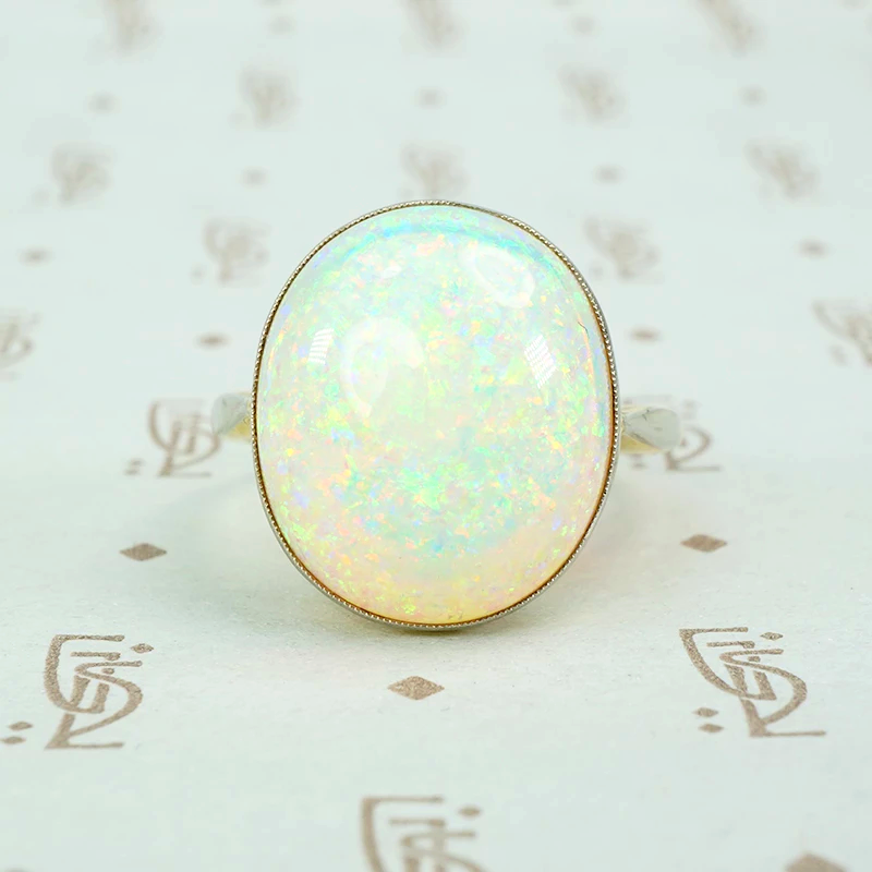 8 carat pinfire opal ring in platinum and 18k yellow gold. 