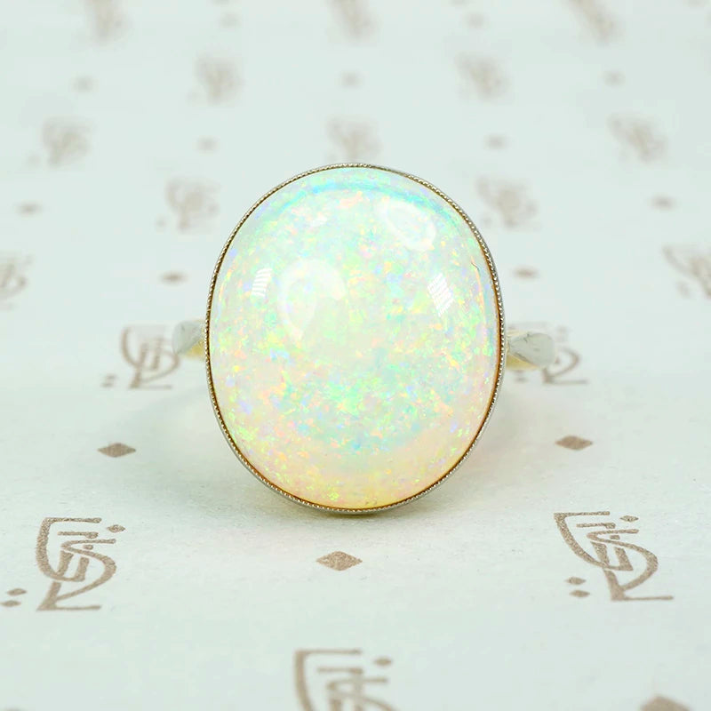8 carat pinfire opal ring in platinum and 18k yellow gold. 
