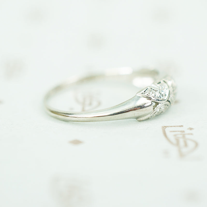 side view of rounded tapered band on edwardian platinum filigree diamond band ring