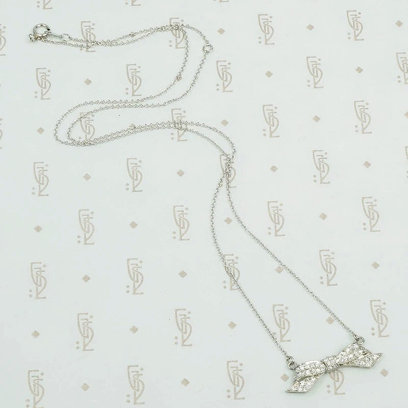 Pavé diamond platinum bow necklace