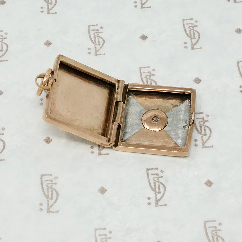 platinum and rose gold locket with omc diamond open
