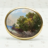 hand painted enamel scene of life on a river set in a 14k yellow gold frame can be worn as a brooch or pendant