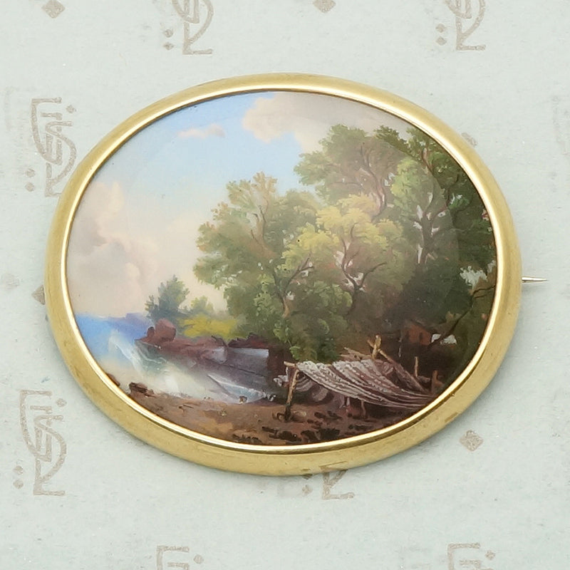 hand painted enamel scene of life on a river set in a 14k yellow gold frame can be worn as a brooch or pendant