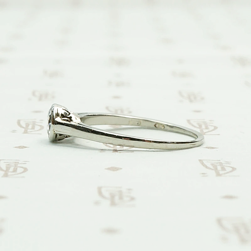 1920s White Gold Bezel Set Diamond Solitaire. Left View.