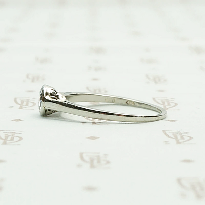 1920s White Gold Bezel Set Diamond Solitaire. Left View.
