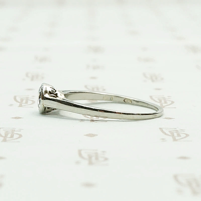 1920s White Gold Bezel Set Diamond Solitaire. Left View.