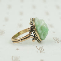 side detail of carved light green jade scarab ring