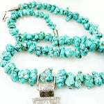 Long strand of Natural Turquoise Nuggets with a Large Silver Cross