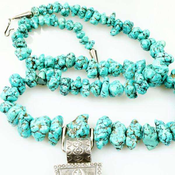 Long strand of Natural Turquoise Nuggets with a Large Silver Cross