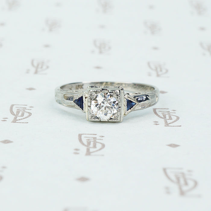 vintage white gold diamond engagement ring with sapphire sides