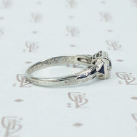 vintage white gold diamond engagement ring with sapphire sides