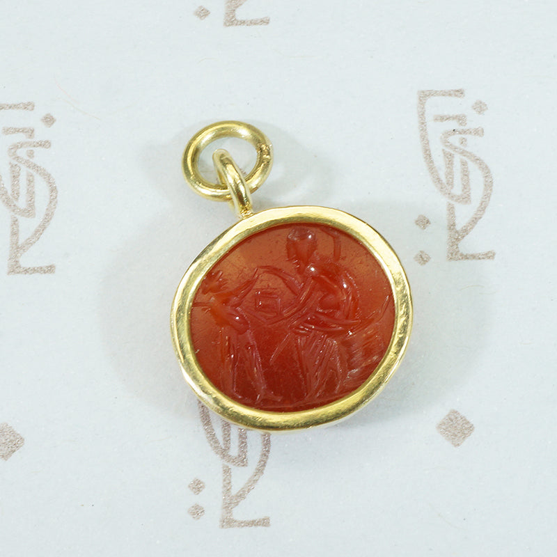 ancient roman carnelian intaglio depicting a satyr and a companion in 18k recycled gold bezel
