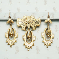 black tracery enamel ivy leaves decorate a gold filled set featuring earrings and a pendant brooch