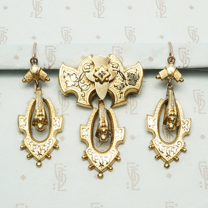 black tracery enamel ivy leaves decorate a gold filled set featuring earrings and a pendant brooch