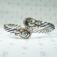 Samuel Benham sterling and 14k yellow gold clamper bracelet set with 2 oval natural blue zircons