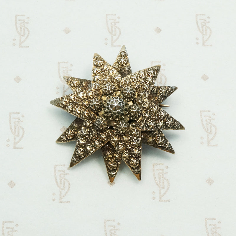 double stack gilded silver star brooch embellished with rivet like designs circa 1890