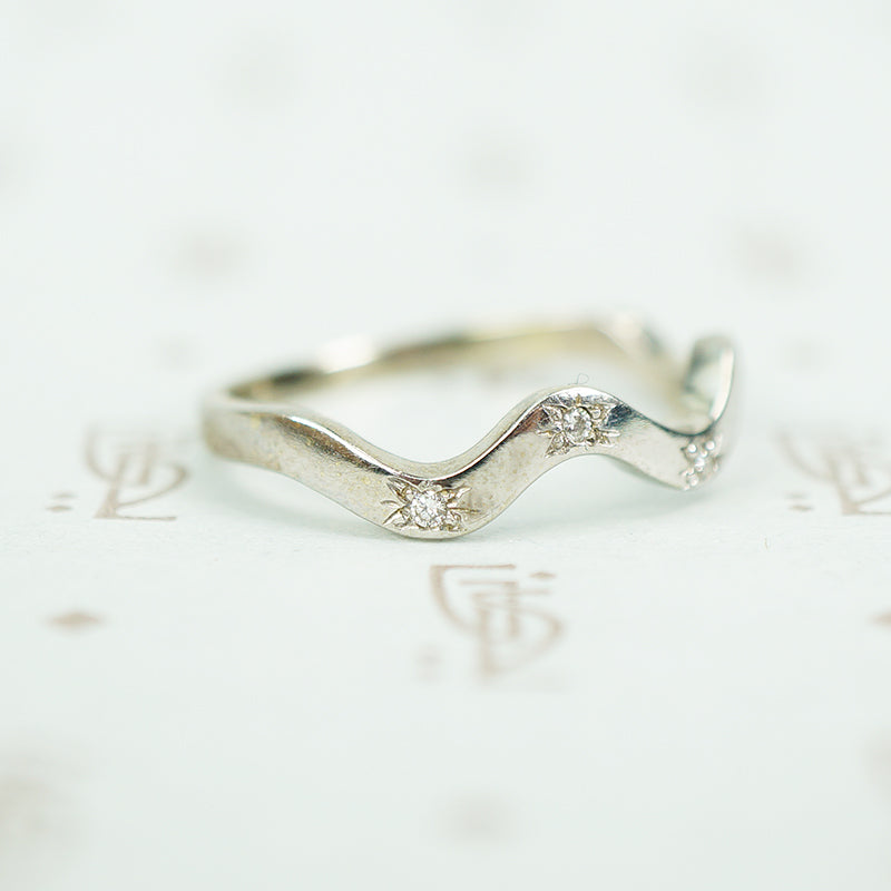 side view of star set 14k white gold recycled diamond wave band