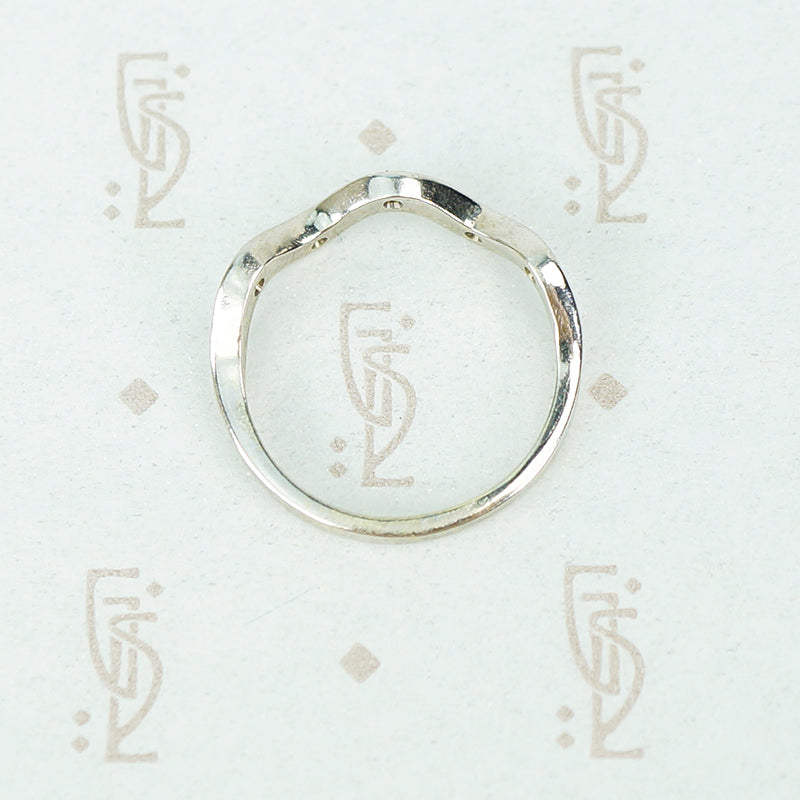 Flat side view of the recycled 14k white gold 5 diamond wave band showing flat back and wave front