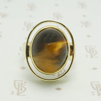 golden brown tigers eye set in a chunky 14k yellow gold mid century modern ring