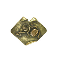 Large coat pin set with glass gem in the color of a citrine dragon and snake battle design