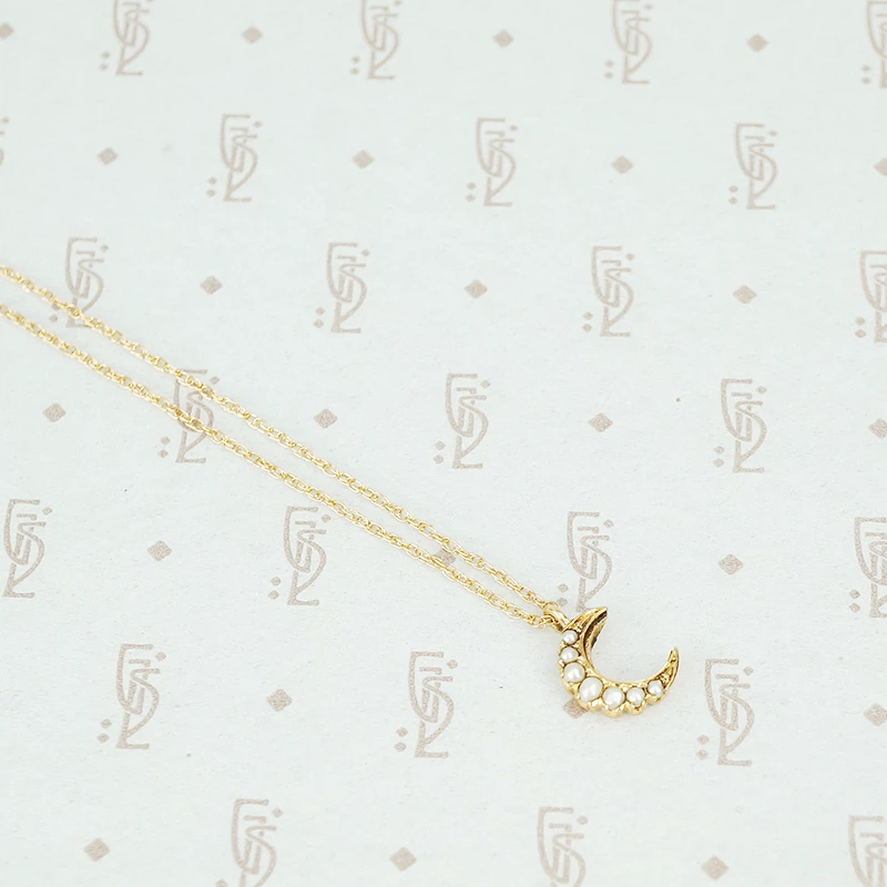 tiny gold crescent moon with pearls