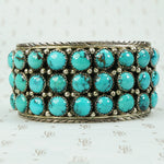 vintage silver cuff bracelet set with chunks of turquoise and signed LJ