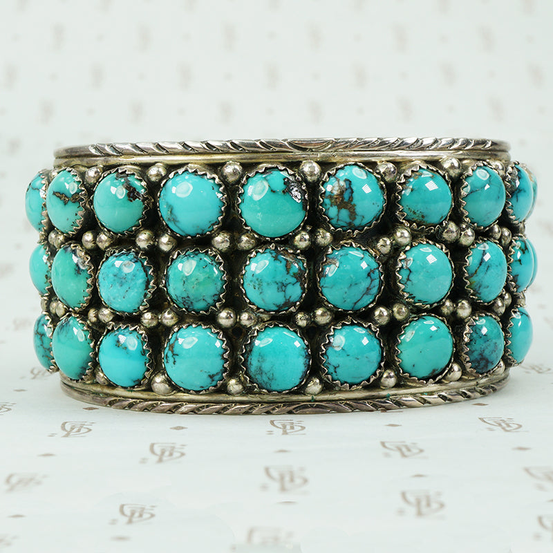 vintage silver cuff bracelet set with chunks of turquoise and signed LJ