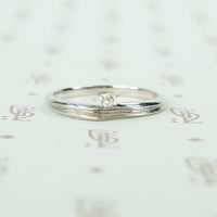 swirly white gold and diamond satelite ring