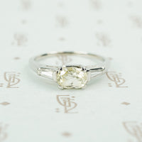 cushion cut yellow sapphire set in platinum with baguette diamond sides