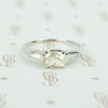cushion cut yellow sapphire set in platinum with baguette diamond sides