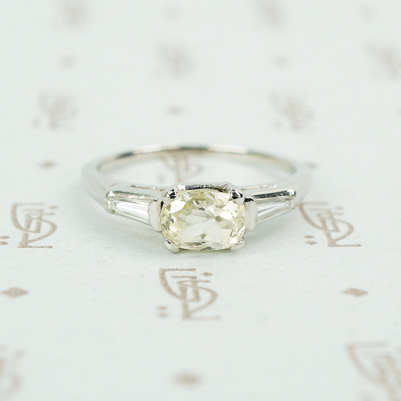 cushion cut yellow sapphire set in platinum with baguette diamond sides