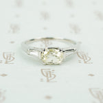 cushion cut yellow sapphire set in platinum with baguette diamond sides
